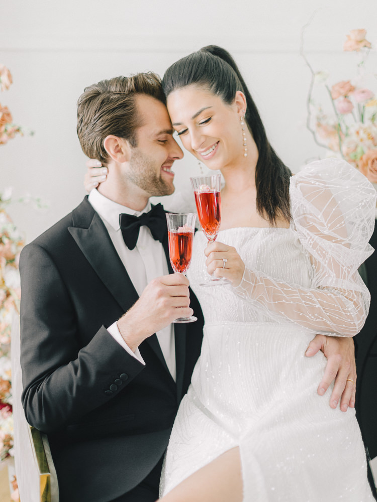 Bride and groom cheers with their champagne to celebrate their wedding