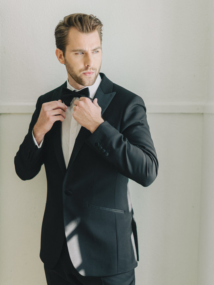 Groom fixes his bowtie during a styled shoot for a modern wedding in Montreal