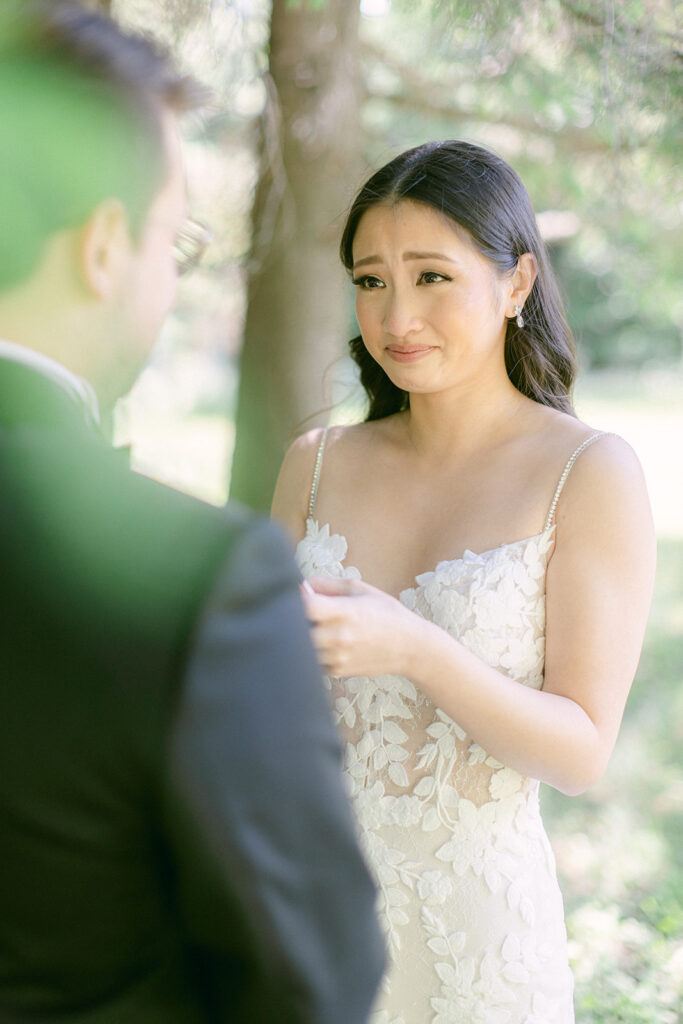 Stunning bride tears up as she sees her groom for their first look on the day of their Montreal wedding