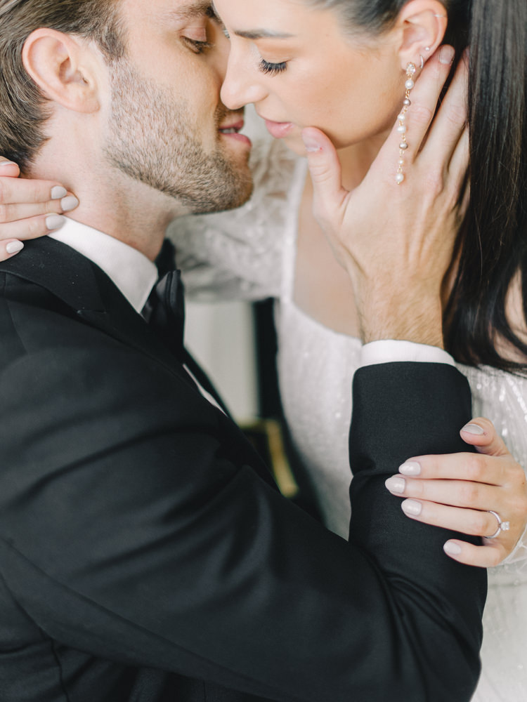 Bride and groom share an almost kiss while their photographer captures the moment