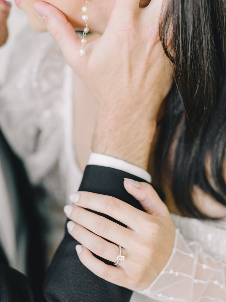 close shot of a groom's hand placed lovingly on his bride's cheek
