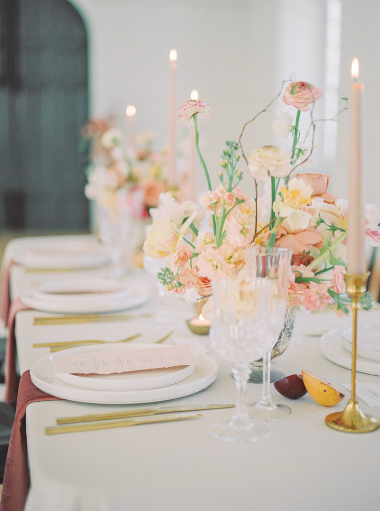 Table setting at a modern, elegant wedding in Montreal with pastel flowers and candles