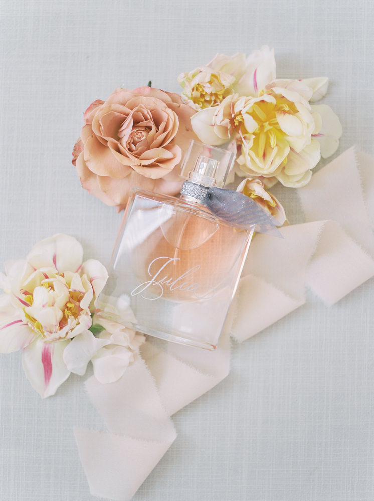 Bride's perfume captured in a colourful photo surrounded by nude-toned flowers