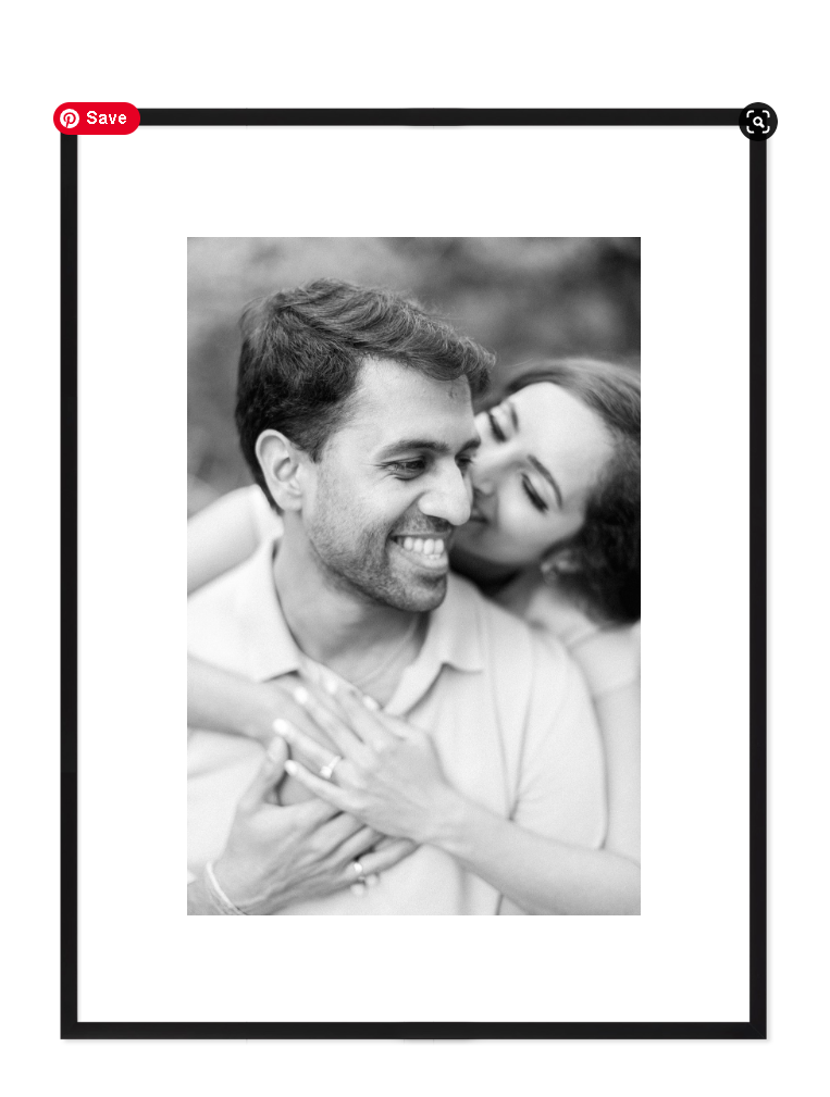black and white engagement photo of a woman holding her significant other from behind him